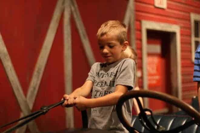 Young boy pulls the reigns on a Bennett buggy ride