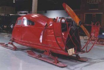Red snowplane on skis with a propeller on the back