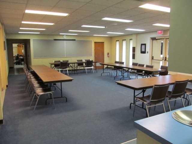 Seminar set-up with long tables and chairs
