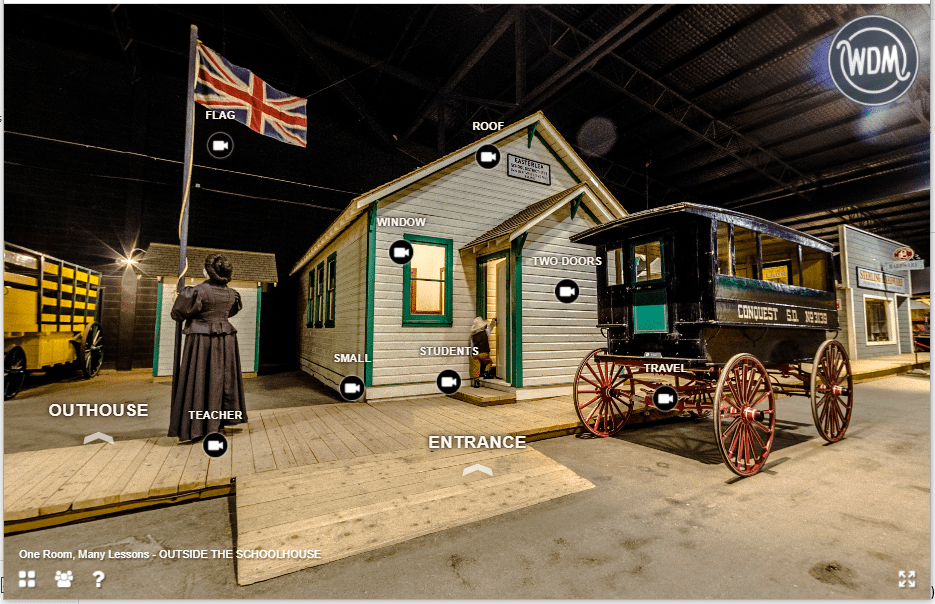 Screenshot of virtual tour showing exterior of a one room schoolhouse on exhibit