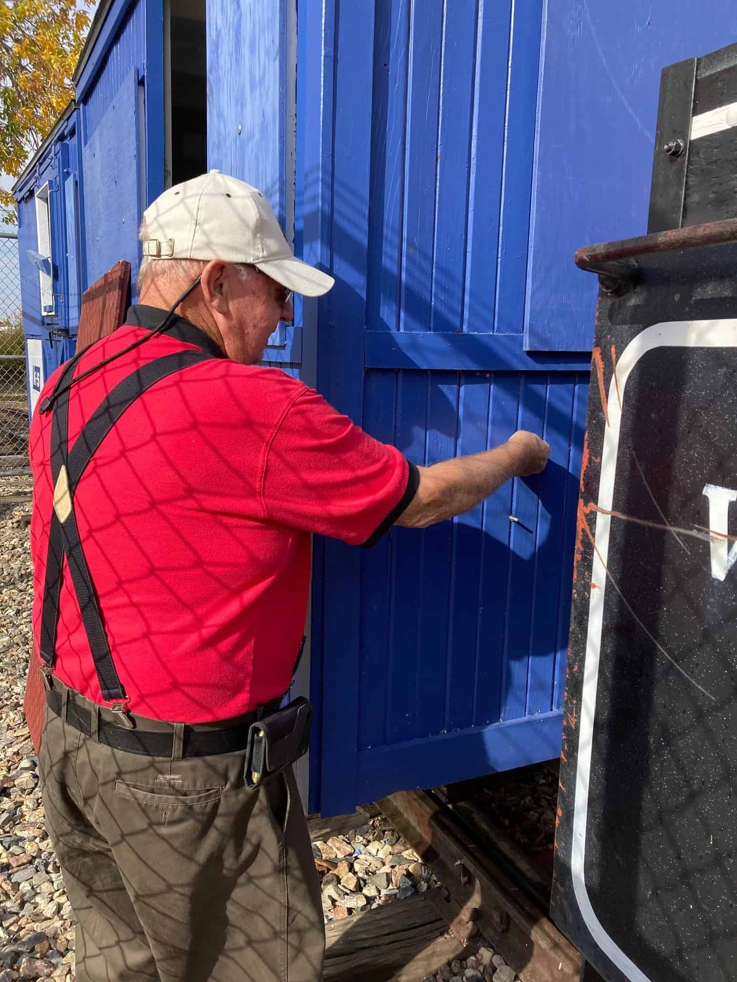 Man beside rail boxcar
