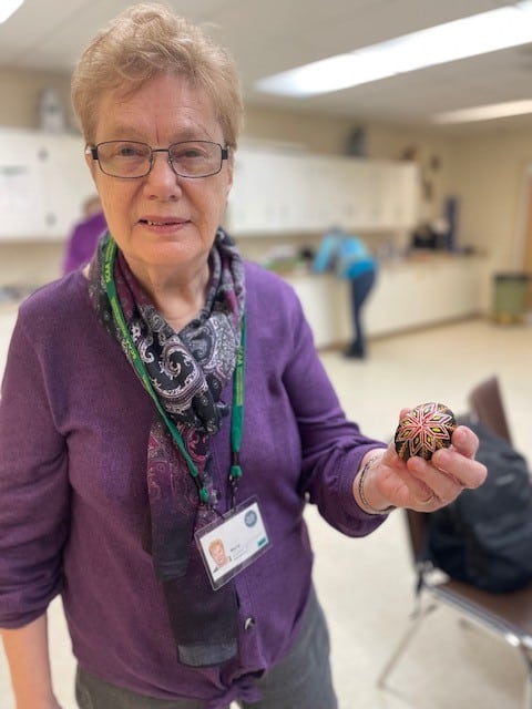 Woman holding Ukrainian style Easter egg