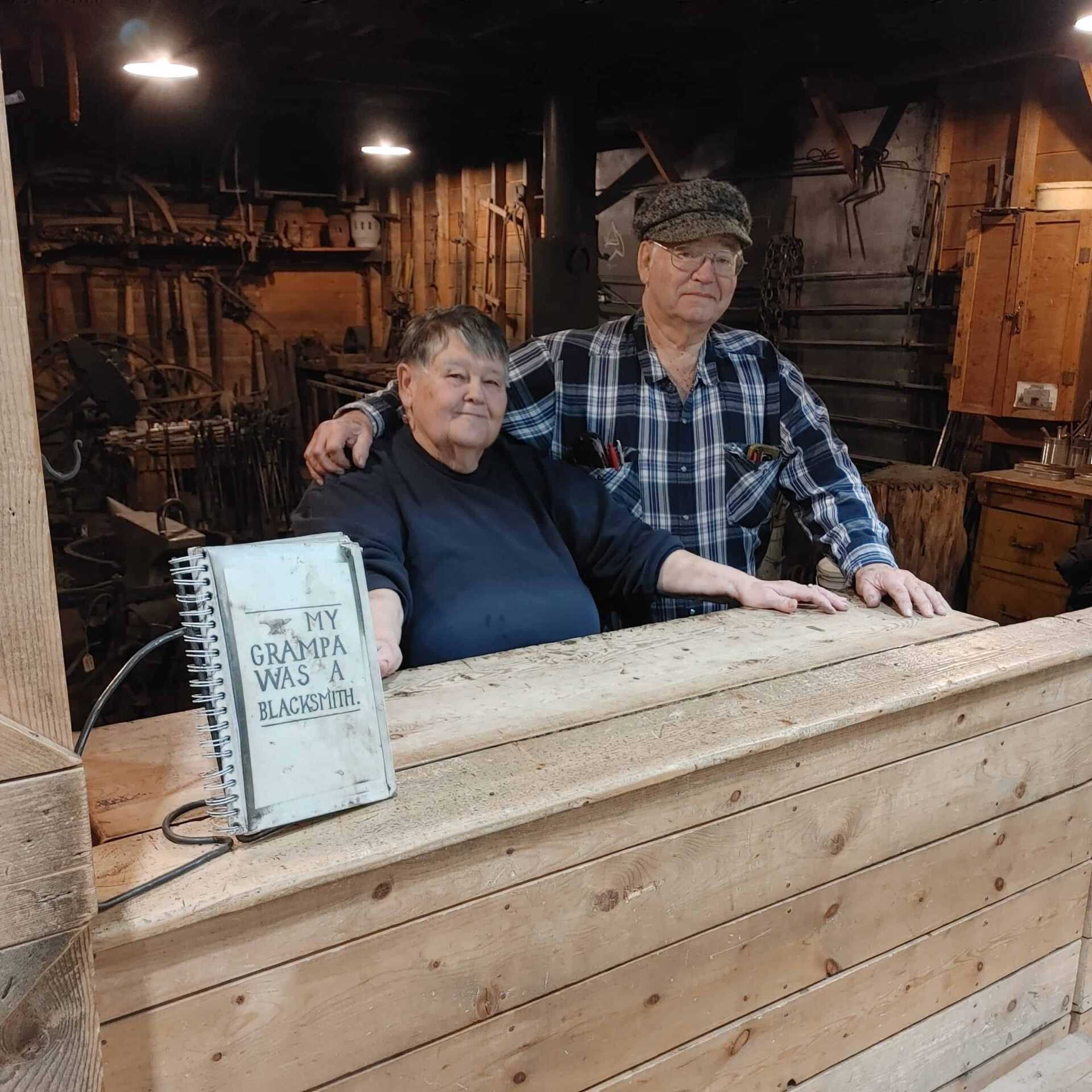 Couple with "My Grandpa Was a Blacksmith" book in front of them