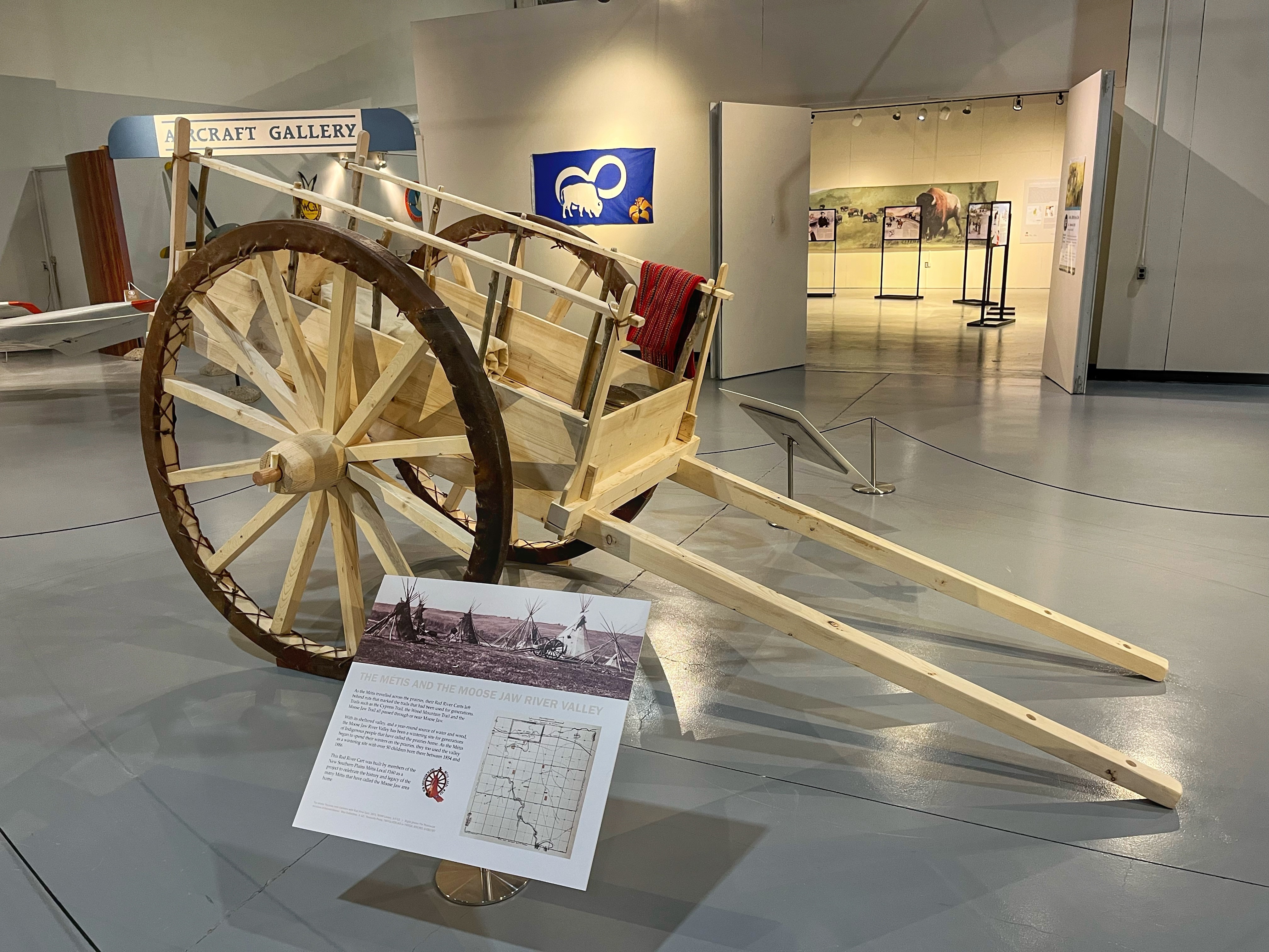 A red river cart on display in the Orientation Gallery.